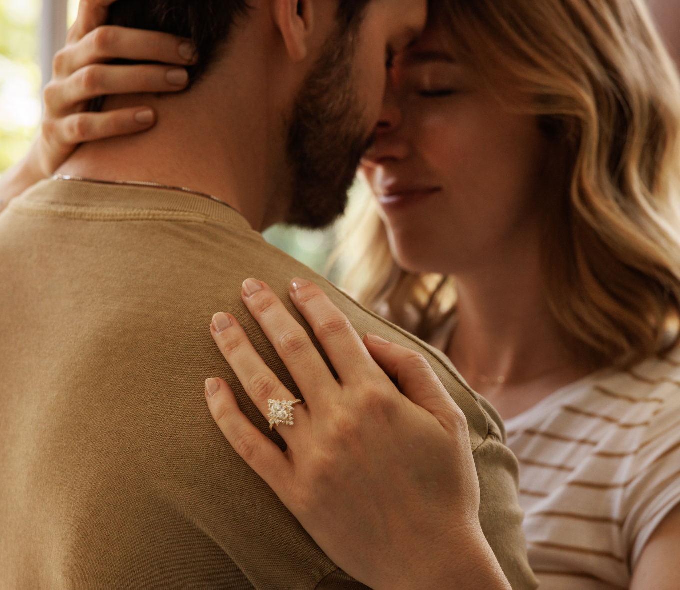 couple hugging after proposal, engagement ring featured on his shoulder. Cypress Halo Engagement Ring A showstopping halo of natural diamonds surrounds the marquise center stone of your choice in this breathtaking engagement ring design. A mix of hand-matched marquise, pear, and round diamonds accents create unique shape, while jaw-dropping pavé dazzles along the quality 14-karat yellow gold band. For more information on selecting your center stone, live chat online, call a customer service representative at 1-866-467-4263, or visit one of our store locations.