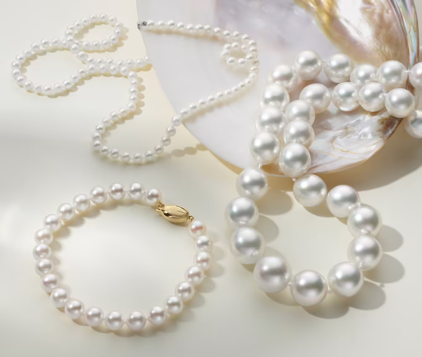 pearl jewelry, two pearl necklaces and one pearl bracelet 11mm Cultured South Sea Pearl Strand (18 in) This classic and elegant pearl strand is sure to complete any fine jewelry collection. The cultured South Sea pearls have been hand-matched for consistent color, size, and shape. 11-14mm cultured South Sea pearls 18-inch strand Secured with a 14-karat white gold ball clasp 4mm Cultured Freshwater Pearl Strand Sophisticated and timeless, this cultured freshwater pearl strand adds instant style to any outfit. A 14-karat white gold fishhook clasp keeps it secure. Our pearl strands are hand matched for color and luster and strung with an individual knot between each pearl, so you’ll never lose one. Cultured freshwater pearls at 4-4.5mm 18-inch length 14k white gold fishhook clasp 7mm Akoya Cultured Pearl Bracelet (7.5 in) This timeless bracelet features seven inches of 7-7.5mm cultured akoya pearls that have been hand-matched for exceptional luster and sheen. Secured by a quality 14 karat yellow gold clasp, this stunning bracelet is a pure classic.