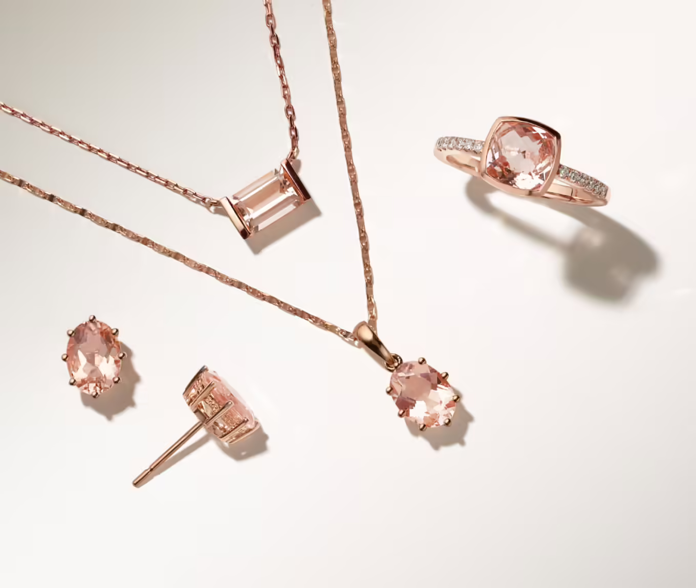 assorted fashion jewelry in rose gold featuring morganite gemstones Hera Morganite Studs (8x6mm) These stud earrings showcase the natural beauty of a pair of hand-matched morganite gemstones, with their peach color and stylish oval shape. They’re crafted in romantic 14-karat rose gold with milgrain detailing around the base of each gemstone for a delicate hidden detail. While stunning enough to complement a special outfit, their solitaire design and secure yet comfortable friction back also make them a great option for daily wear. 2 oval natural morganite gemstones at approx. 8x6mm Friction back 14k rose gold Kenza Morganite Pendant (20 in) Simply stunning, this pendant shows off a single baguette natural peach morganite gemstone positioned in a unique east-west (horizontal) orientation. It’s crafted in vivid 14-karat rose gold, giving it a beautiful blush color palette that pairs well with nearly any look. A matching cable chain with a secure lobster clasp keeps this necklace secure. 1 baguette natural peach morganite gemstone at approx. 7x5mm Approx. 3/8-inch pendant width 20-inch adjustable cable chain Lobster clasp 14k rose gold Hera Morganite Pendant This solitaire pendant showcases the natural beauty of the morganite gemstone at its center, with its peach color and stylish oval shape. It’s crafted in romantic 14-karat rose gold with milgrain detailing around the base of the gemstone for a delicate hidden detail. While stunning enough to complement a special outfit, its solitaire design also makes it a great option for daily wear. 1 oval natural morganite gemstone at approx. 8x6mm Approx. 5/8-inch pendant length 18-inch anchor chain Lobster clasp 14k rose gold Elara Peach Morganite and Diamond Ring in 14K Rose Gold This lovely ring features one square cushion-cut peach natural morganite gemstone (approx. 1.45 carats TW) and twelve round natural diamonds (approx. .14 carat TW). This piece is crafted from quality 14 karat rose gold, has a total gem weight of approximately 1.59 carats and measures 1.5mm wide at the band. Add a custom engraving to complete the look. For assistance on engraving, Live Chat online, call an online customer service representative at 1-866-467-4263, or visit one of our store locations.