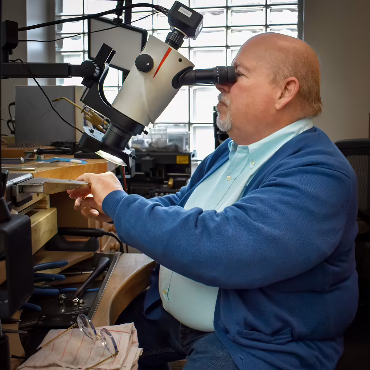 expert Shane Co. jeweler at work in jewelry store jewelers' workshop