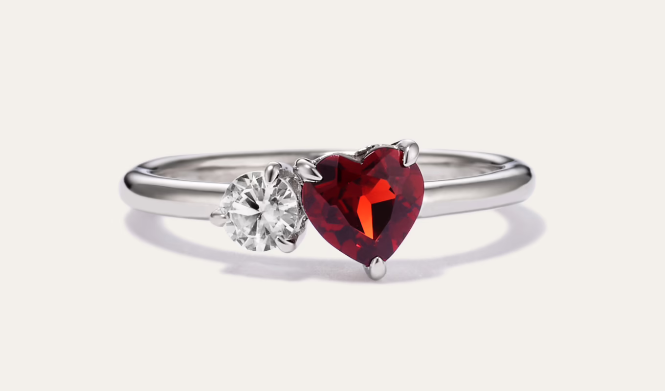 Toi et Moi Garnet and White Sapphire Ring in Sterling Silver Simple and romantic, this beautiful ring is sure to make them smile. The natural garnet gemstone makes the perfect gift for a January birthday. The accenting white natural sapphire has been hand-selected by our team for exceptional color. The sterling silver is malleable, so you can personalize this ring with a custom engraving. Sterling silver Natural garnet gemstone at approx. .80 ct. t.w. White natural sapphire at approx. .40 ct. t.w. 1.5mm band width Engravable and resizable