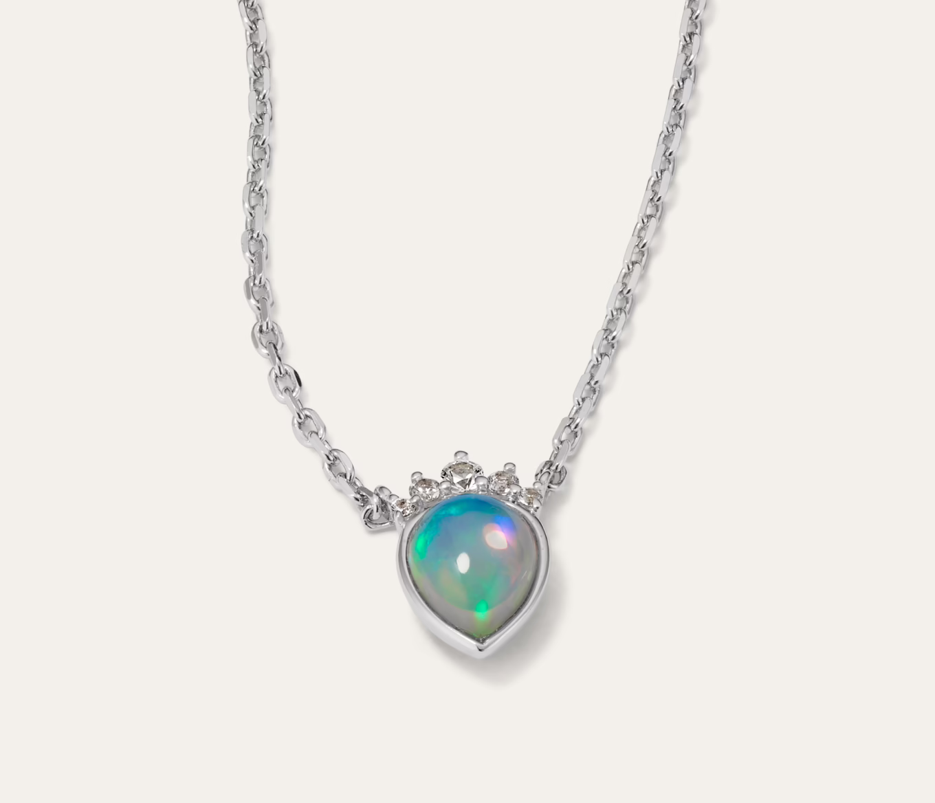 Tiara Opal & White Sapphire Pendant Natural white sapphires crown a pear-shaped natural opal in this luminous pendant. Complete with an adjustable cable chain and secure lobster clasp, this sterling silver necklace makes a beautiful gift or daily accessory. To care for natural opals, gently clean in warm water with mild detergent and a soft toothbrush or cloth. Avoid bleach, chemicals, cleaners, and rapid temperature changes. 1 pear-shaped natural opal at approx. 8x6mm 5 round natural white sapphire accents at approx. 0.05 tcw Approx. 1/2-inch pendant length 20-inch adjustable cable chain Lobster clasp Sterling silver