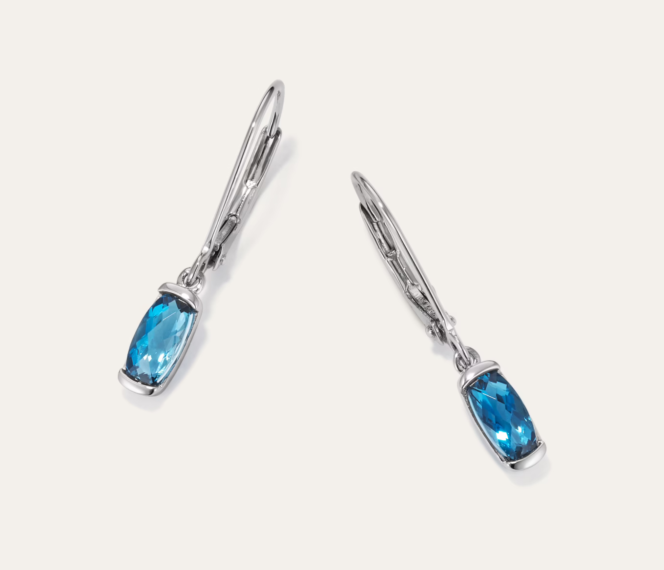 Melina Blue Topaz Drop Earrings - Sterling Silver These colorful drop earrings each feature a London blue natural topaz gemstone in a unique elongated cushion cut. They’re crafted with care in quality sterling silver. 2 elongated cushion cut London blue natural topaz gemstones at approx. 7x3.5mm Dangle design Approx. 3/8-inch length Lever back Sterling silver